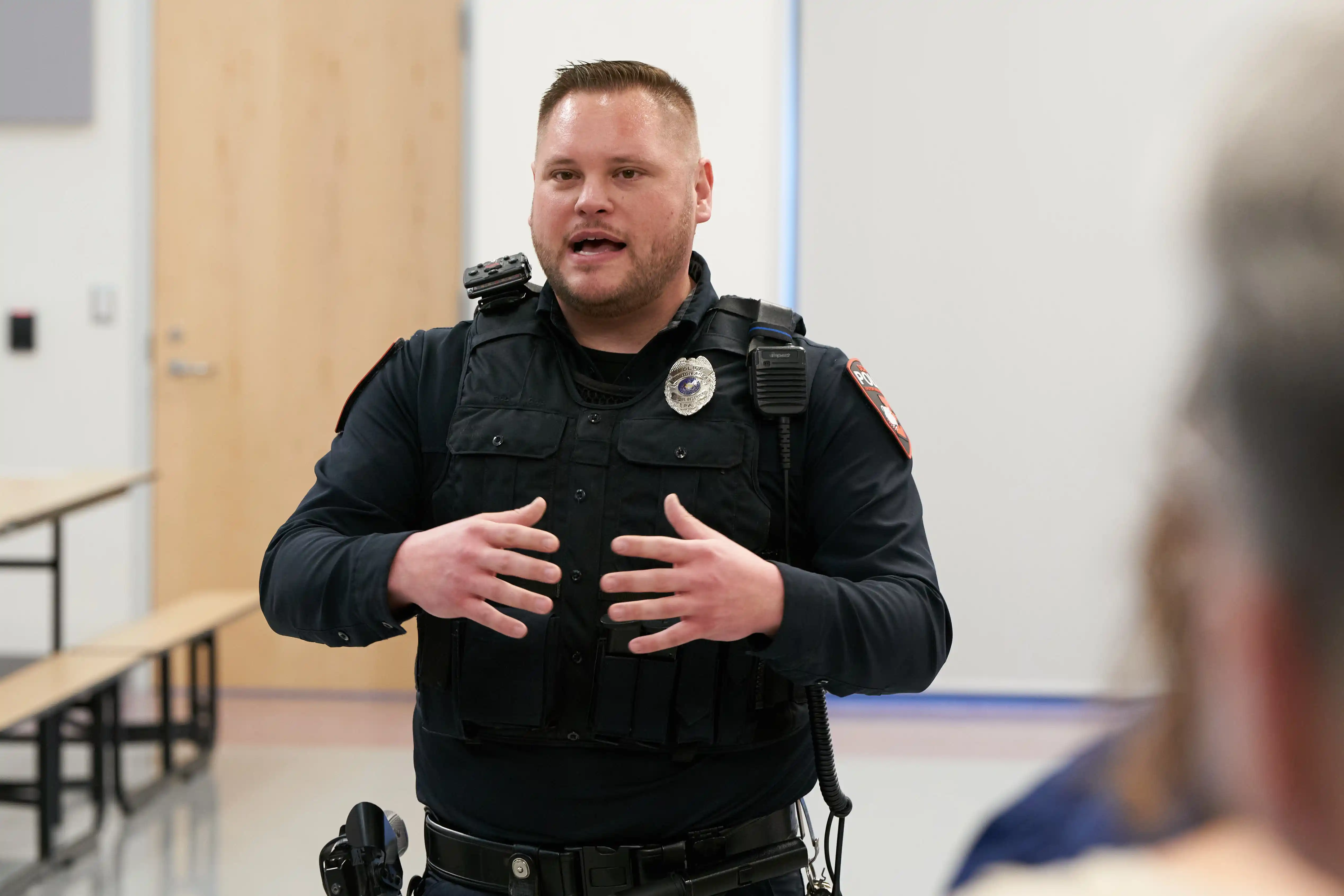 School police Officer Stephen Schleig gathers local leaders prior to...