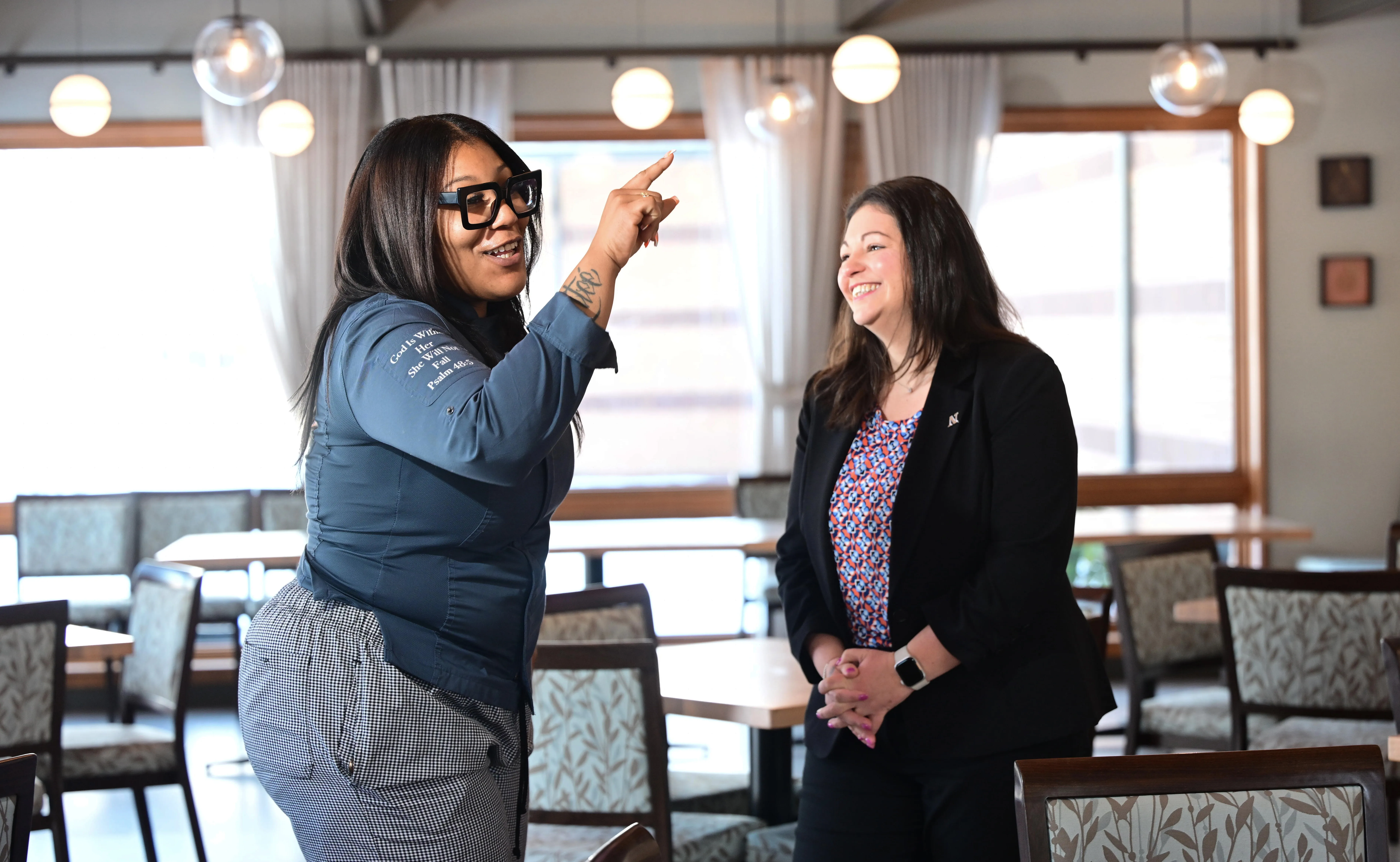 Janaja D. Harris interacts playfully with Jacqui Stackhouse, assistant director...