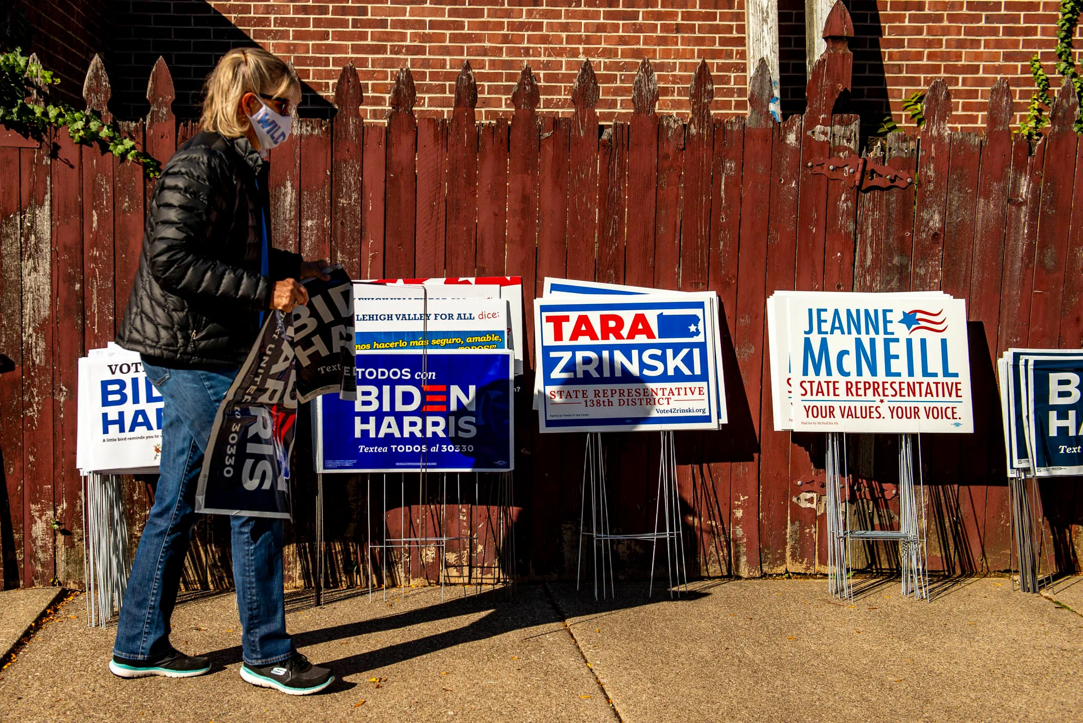 Volunteer Joan Howe of Bethlehem Township helps assembles signs for...