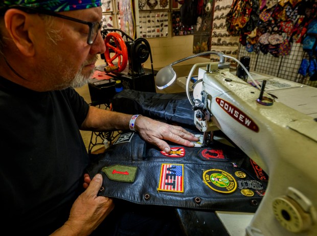 Timothy Sanborn sews a patch onto a leather vest at his booth during the Lehigh Valley Motorcycle Expo on Friday, Feb. 6, 2026, at the Agri-Plex at the Allentown Fairgrounds in Allentown. The expo continues 9 a.m. to 7 p.m. Saturday and 9 a.m. to 3 p.m. Sunday. (April Gamiz/The Morning Call)