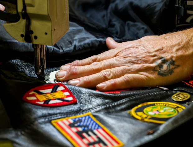 Timothy Sanborn sews a patch onto a leather vest at his booth during the Lehigh Valley Motorcycle Expo on Friday, Feb. 6, 2026, at the Agri-Plex at the Allentown Fairgrounds in Allentown. The expo continues 9 a.m. to 7 p.m. Saturday and 9 a.m. to 3 p.m. Sunday. (April Gamiz/The Morning Call)