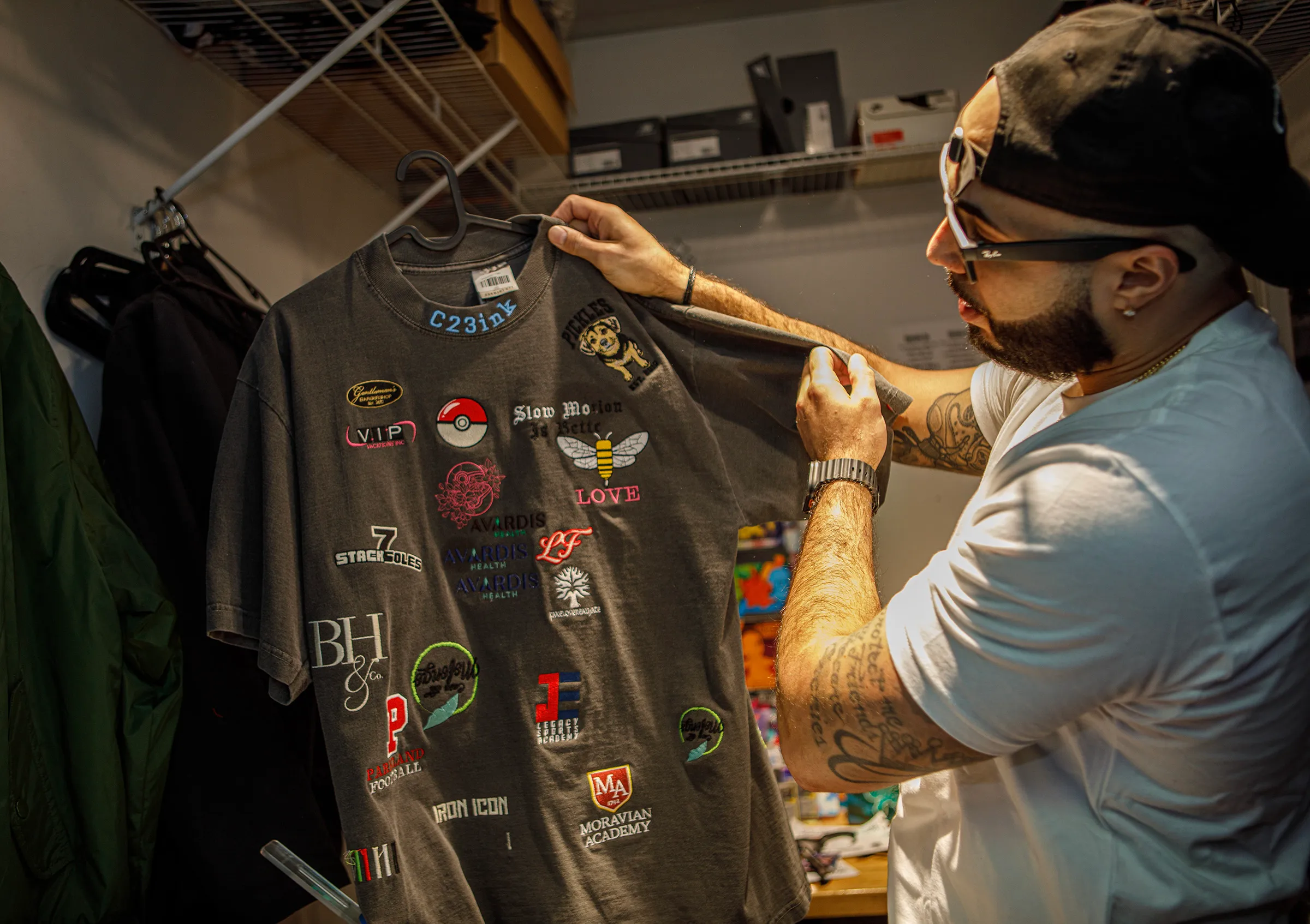 Tattoo artist Christian Colon shows samples of embroidery decals he...