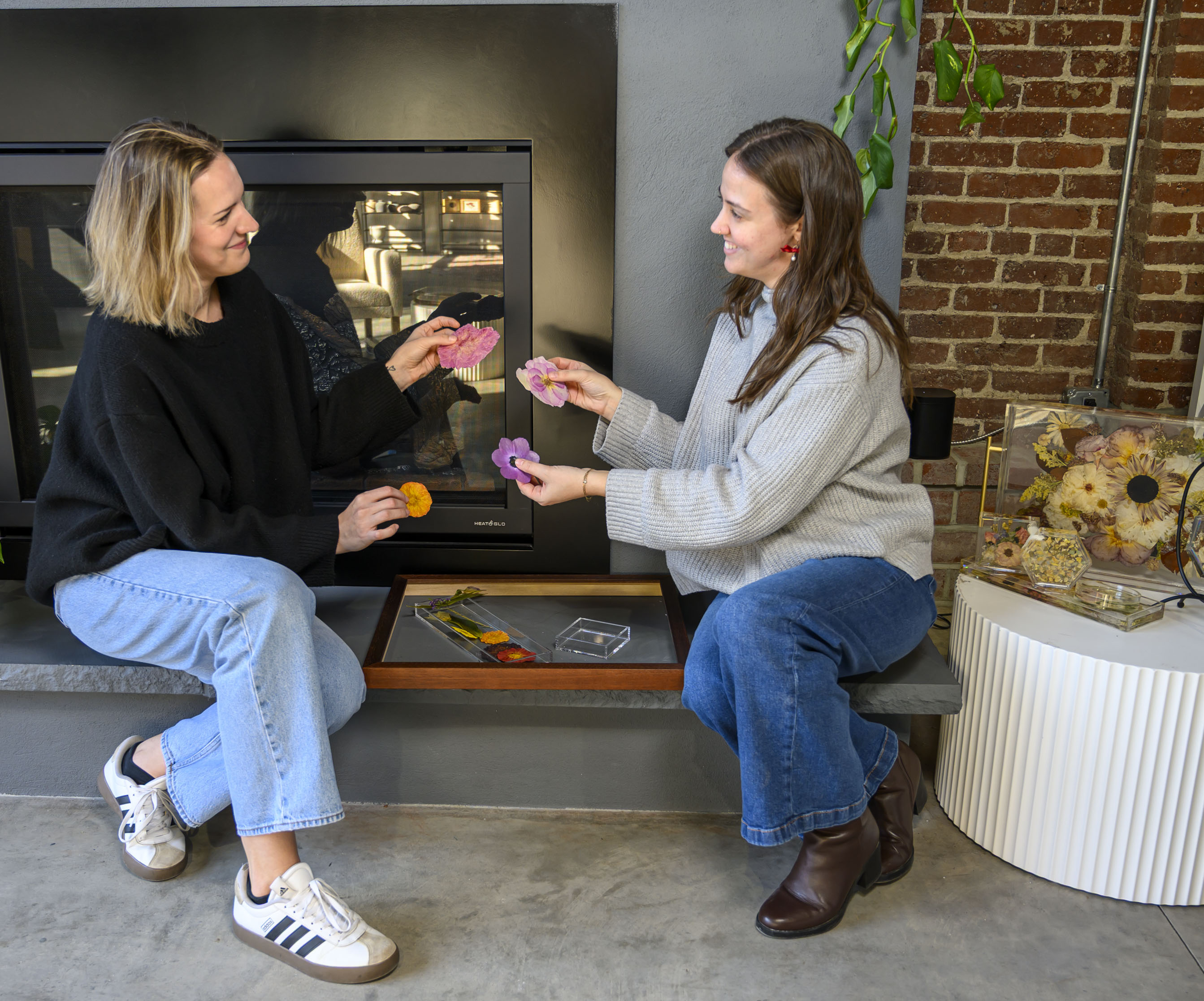 Staff members Abby Paradysz and Nikole Cingari collaborate on floral...