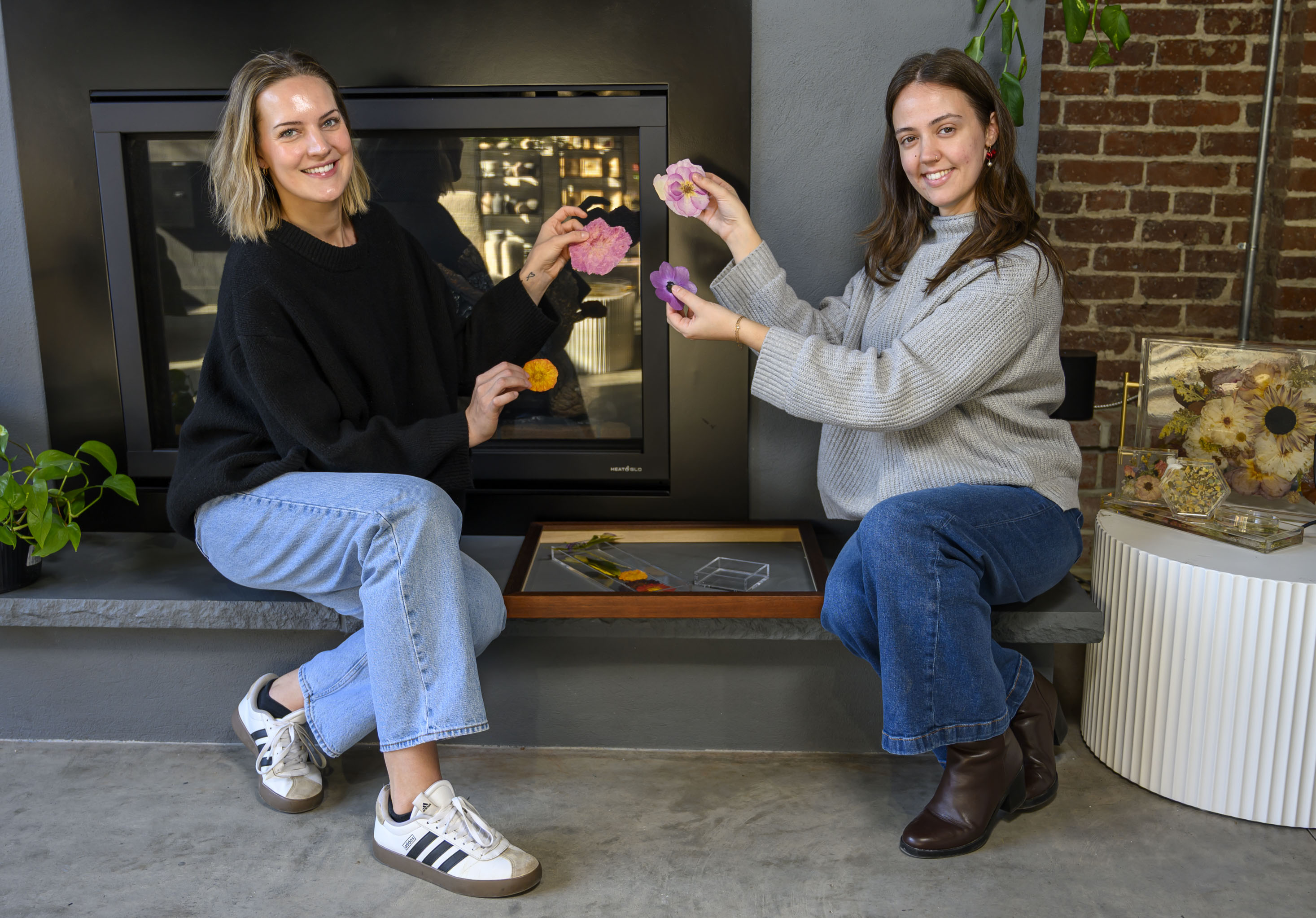 Staff members Abby Paradysz and Nikole Cingari collaborate on floral...