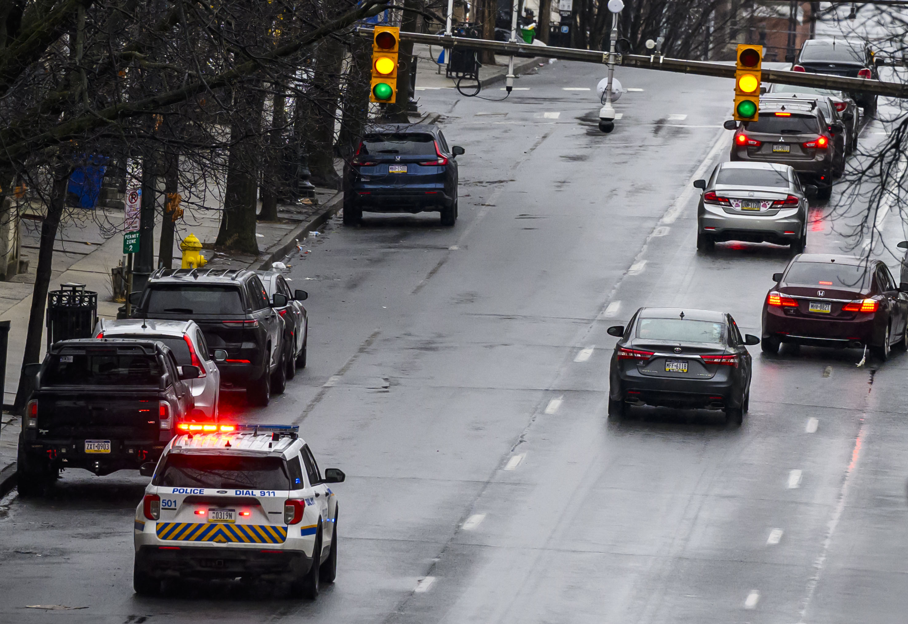 Allentown police drive slowly past parked vehicles Sunday, Feb. 22, 2026, announcing over a loud speaker that vehicles must be moved or will be ticketed and towed due to being parked along a snow emergency route on Seventh Street in Allentown. The city declared an emergency ahead of a winter storm Sunday into Monday that was expected at various points to drop anywhere from 7 to 18 inches of snow in the region. (April Gamiz/The Morning Call)