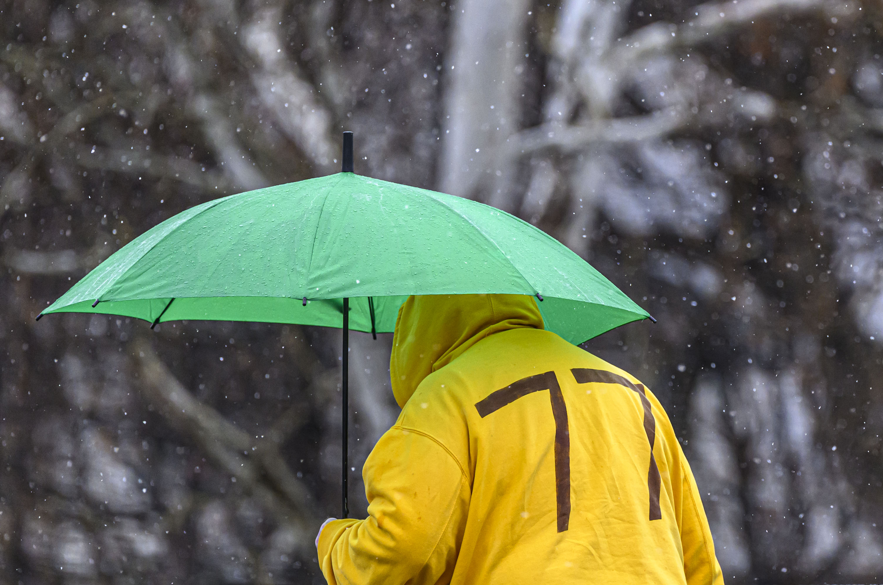 A pedestrian uses an umbrella to keep dry as they walk Sunday, Feb. 22, 2026, as the weather changed from rain to flurries in Bethlehem. A winter storm was expected to drop 7-14 inches of snow in the region Sunday into Monday, though the National Weather Service said there was a lot of uncertainty about the total. (April Gamiz/The Morning Call)