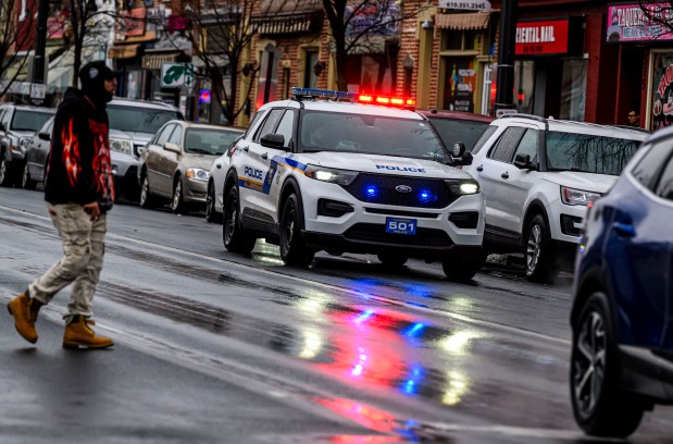 Allentown police drive slowly past parked vehicles Sunday, Feb. 22, 2026, announcing over a loud speaker that vehicles must be moved or will be ticketed and towed due to being parked along a snow emergency route on Seventh Street in Allentown. The city declared an emergency ahead of a winter storm Sunday into Monday that was expected at various points to drop anywhere from 7 to 18 inches of snow in the region. (April Gamiz/The Morning Call)