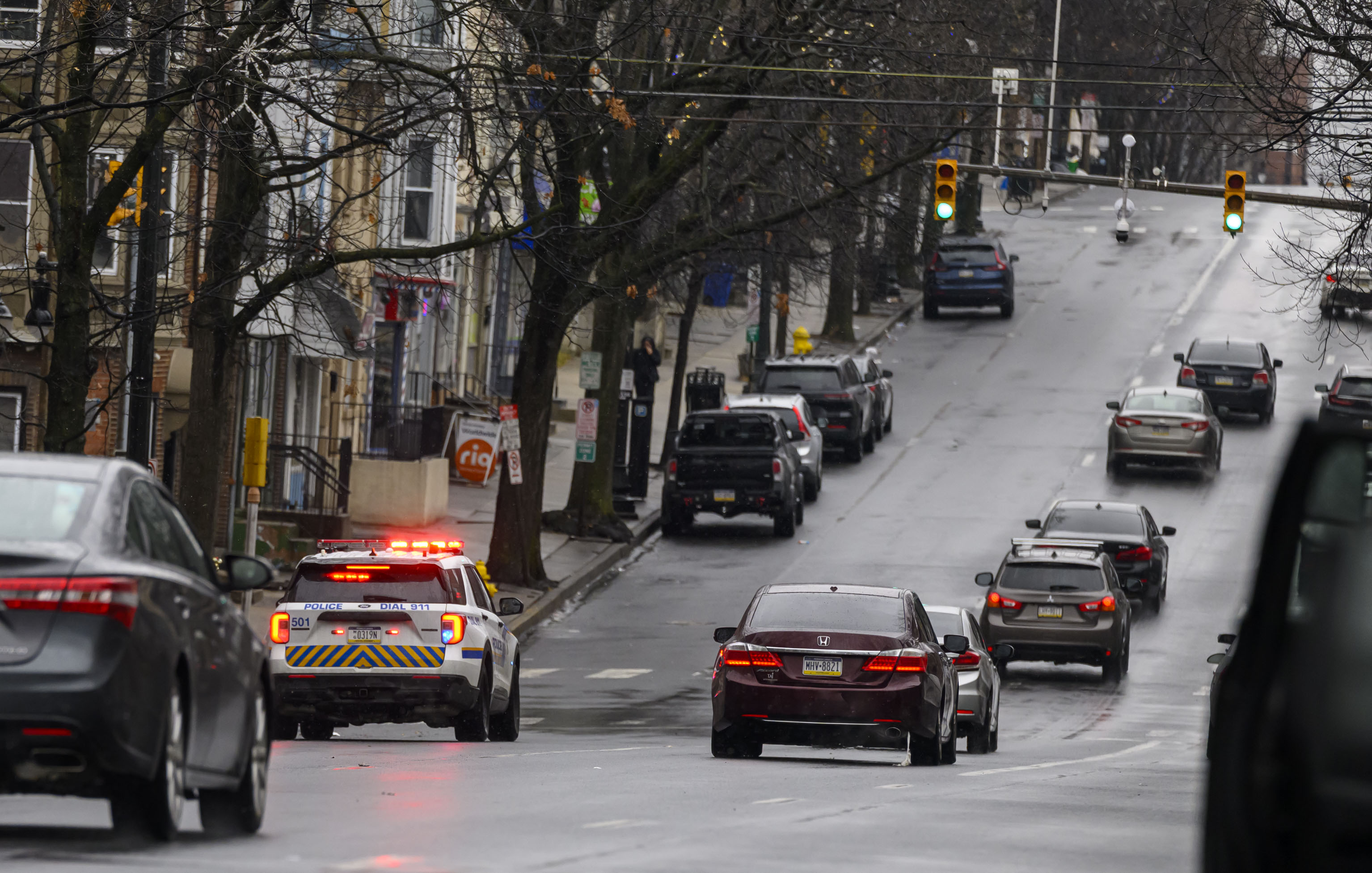 Allentown police drive slowly past parked vehicles Sunday, Feb. 22, 2026, announcing over a loud speaker that vehicles must be moved or will be ticketed and towed due to being parked along a snow emergency route on Seventh Street in Allentown. The city declared an emergency ahead of a winter storm Sunday into Monday that was expected at various points to drop anywhere from 7 to 18 inches of snow in the region. (April Gamiz/The Morning Call)