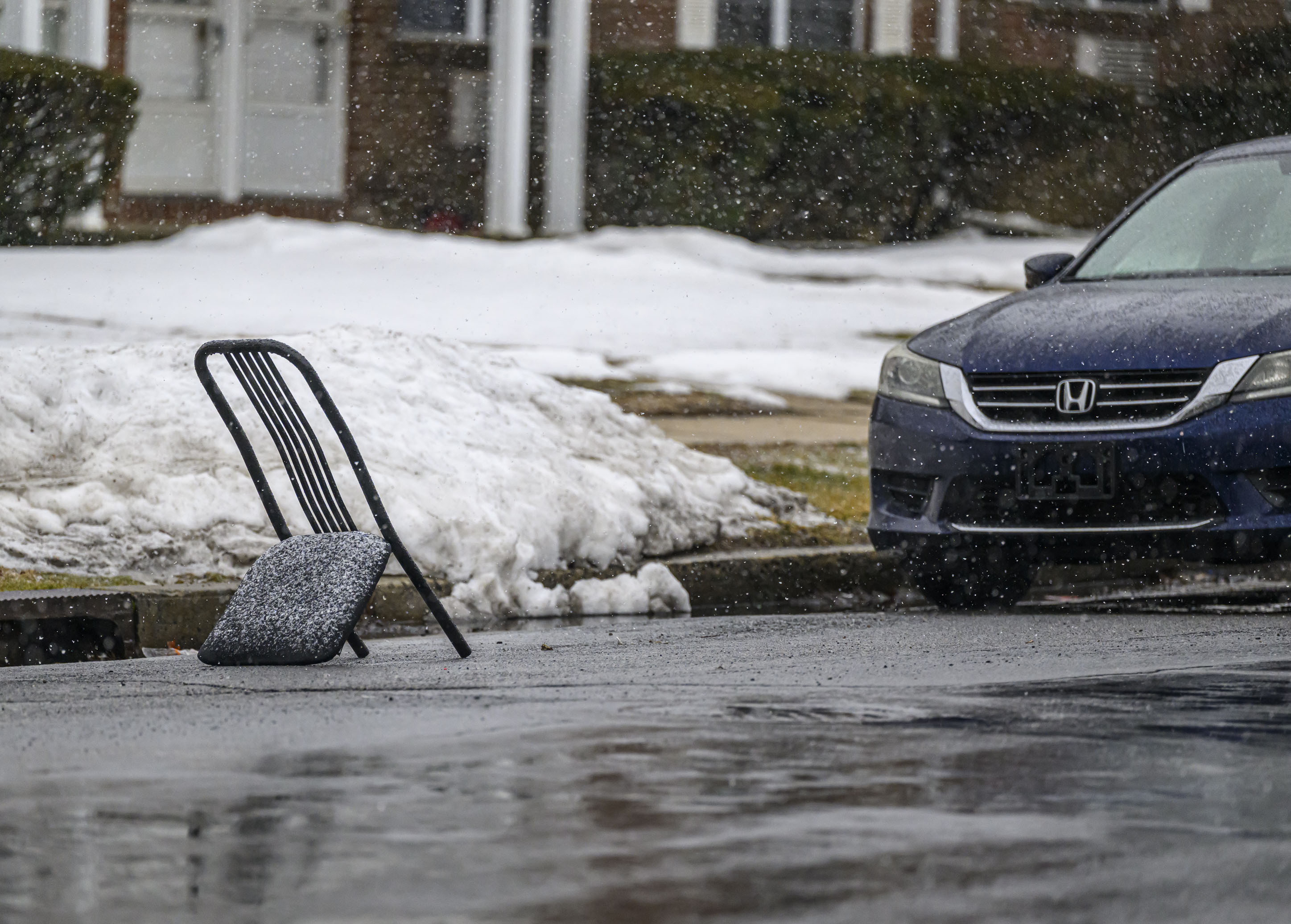 A chair is used to "save a parking spot" on the street Sunday, Feb. 22, 2026, in Bethlehem. A winter storm was expected to drop 7-14 inches of snow in the region Sunday into Monday, though the National Weather Service said there was a lot of uncertainty about the total. (April Gamiz/The Morning Call)