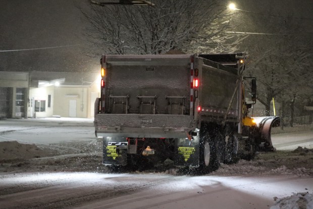 City trucks plow as snow falls late in the evening Sunday, Feb. 22, 2026, in Bethlehem. A winter storm was expected to drop 7-14 inches of snow in the region Sunday into Monday, though the National Weather Service said there was uncertainty about the total. (Rich Rolen/Special to The Morning Call)