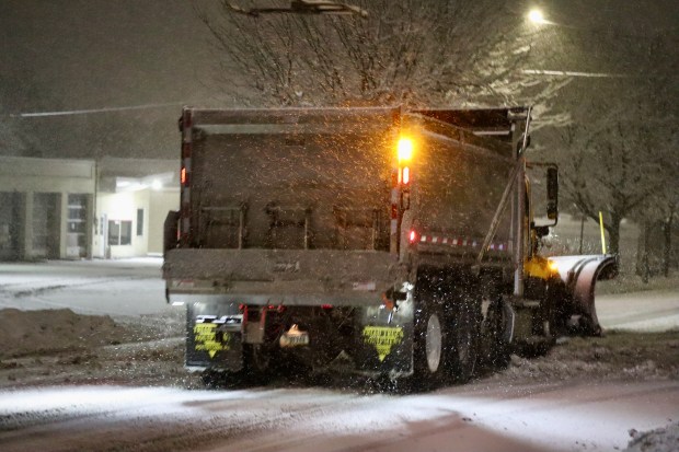 City trucks plow as snow falls late in the evening Sunday, Feb. 22, 2026, in Bethlehem. A winter storm was expected to drop 7-14 inches of snow in the region Sunday into Monday, though the National Weather Service said there was uncertainty about the total. (Rich Rolen/Special to The Morning Call)