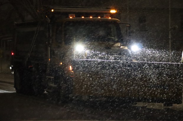 City trucks plow as snow falls late in the evening Sunday, Feb. 22, 2026, in Bethlehem. A winter storm was expected to drop 7-14 inches of snow in the region Sunday into Monday, though the National Weather Service said there was uncertainty about the total. (Rich Rolen/Special to The Morning Call)
