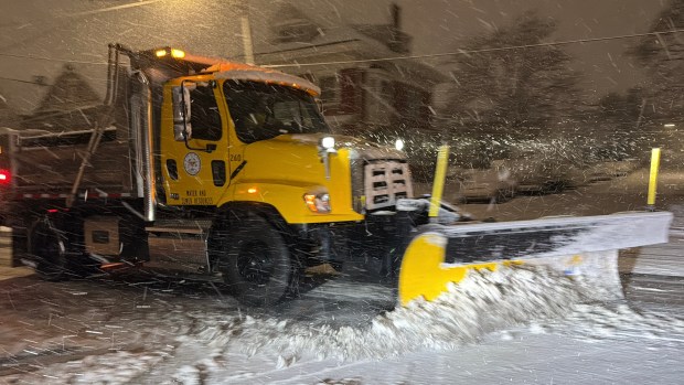 City trucks plow as snow falls late in the evening Sunday, Feb. 22, 2026, in Bethlehem. A winter storm was expected to drop 7-14 inches of snow in the region Sunday into Monday, though the National Weather Service said there was uncertainty about the total. (Rich Rolen/Special to The Morning Call)