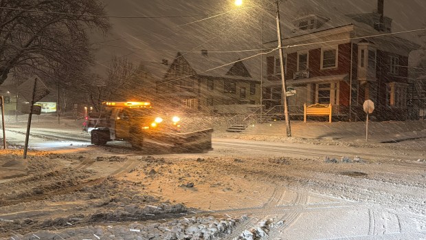 City trucks plow as snow falls late in the evening Sunday, Feb. 22, 2026, in Bethlehem. A winter storm was expected to drop 7-14 inches of snow in the region Sunday into Monday, though the National Weather Service said there was uncertainty about the total. (Rich Rolen/Special to The Morning Call)
