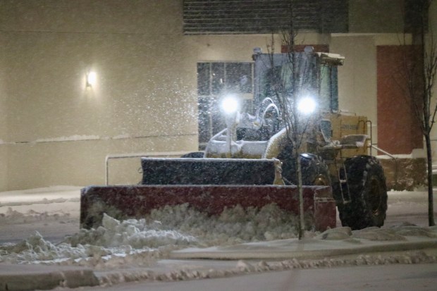 City trucks plow as snow falls late in the evening Sunday, Feb. 22, 2026, in Bethlehem. A winter storm was expected to drop 7-14 inches of snow in the region Sunday into Monday, though the National Weather Service said there was uncertainty about the total. (Rich Rolen/Special to The Morning Call)