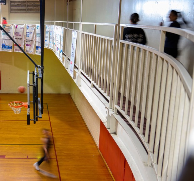 People walk the indoor track as people play basketball below Tuesday, Feb. 24, 2026, at YMCA of Easton in Easton. River Crossing YMCA is holding "Try the Y" for free Feb. 23 - March 1, 2026, at its branches in Lehigh, Northampton, Bucks and Hunterdon counties; new members can sign up without needing to pay a join fee through March 8. (April Gamiz/The Morning Call)