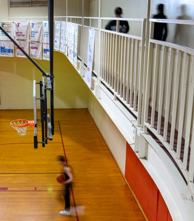 People walk the indoor track as people play basketball below Tuesday, Feb. 24, 2026, at YMCA of Easton in Easton. River Crossing YMCA is holding "Try the Y" for free Feb. 23 - March 1, 2026, at its branches in Lehigh, Northampton, Bucks and Hunterdon counties; new members can sign up without needing to pay a join fee through March 8. (April Gamiz/The Morning Call)