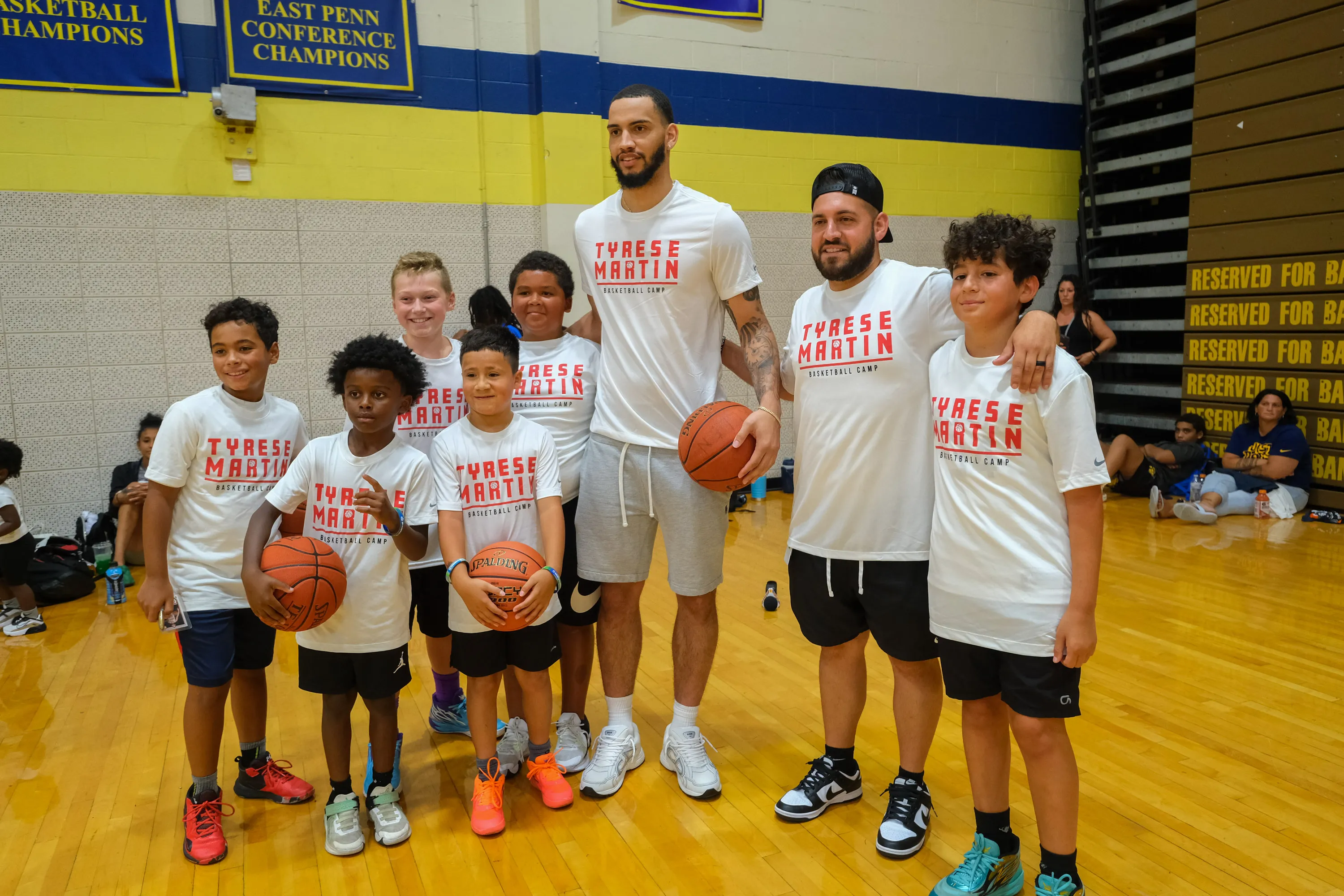 Atlanta Hawks player and Allen Alumni, Tyrese Martin, center, poses...