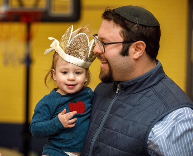 Rabbi Moshe Kurtz, of Congregation Sons of Israel in Allentown, holds his daughter Layla, 1, dressed as Queen Esther during a Purim celebration Wednesday, Feb. 25, 2026, at the Jewish Day School of the Lehigh Valley in Allentown. Purim celebrates the biblical story of Esther's deliverance of the Jews in Persia from a massacre plotted by Haman. The holiday, which is marked by the retelling of the Book of Esther, gift giving, meals and costumes, begins this year on Monday evening and continues into Tuesday, March 3, 2026. (Jane Therese/Special to The Morning Call)