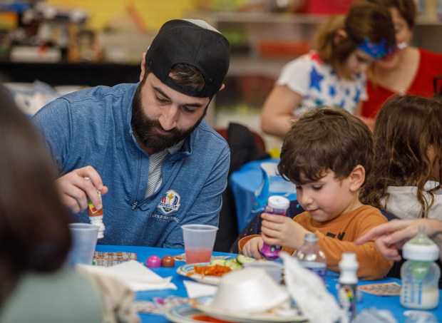 Stephen Loetzbeier of Salisbury Township plays Bingo with his son Owen, 5, during a Purim celebration Wednesday, Feb. 25, 2026, at the Jewish Day School of the Lehigh Valley in Allentown. Purim celebrates the biblical story of Esther's deliverance of the Jews in Persia from a massacre plotted by Haman. The holiday, which is marked by the retelling of the Book of Esther, gift giving, meals and costumes, begins this year on Monday evening and continues into Tuesday, March 3, 2026. (Jane Therese/Special to The Morning Call)