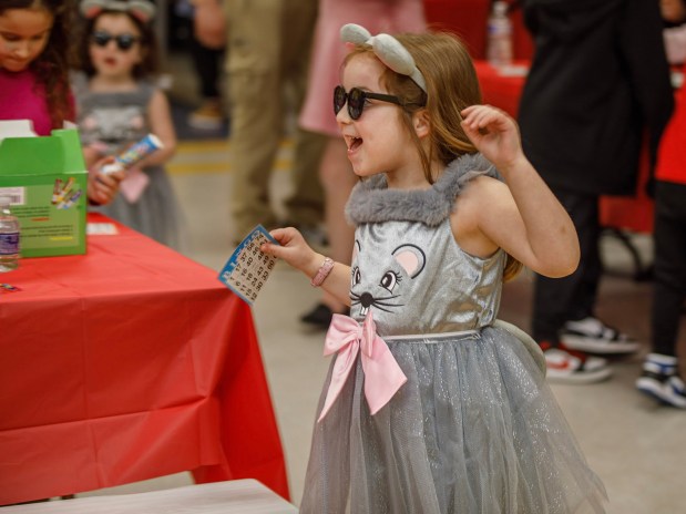 Sophie Meyerson, 4, of Allentown wins at Bingo during a Purim celebration Wednesday, Feb. 25, 2026, at the Jewish Day School of the Lehigh Valley in Allentown. Purim celebrates the biblical story of Esther's deliverance of the Jews in Persia from a massacre plotted by Haman. The holiday, which is marked by the retelling of the Book of Esther, gift giving, meals and costumes, begins this year on Monday evening and continues into Tuesday, March 3, 2026. (Jane Therese/Special to The Morning Call)