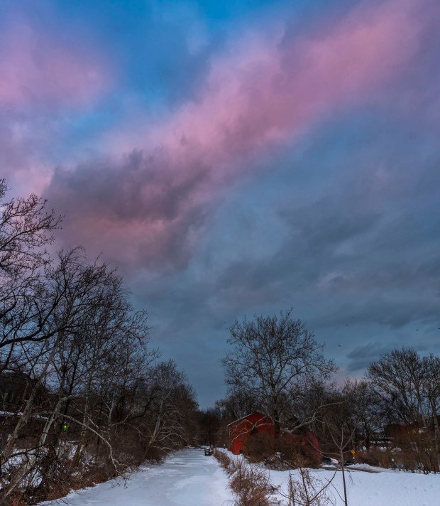 A streak of pink clouds moves through the sky above the frozen Lehigh Canal at sunset Wednesday, Feb 11, 2026, at Sand Island Park in Bethlehem. Starting this week, the sun sets after 5:30 p.m. (April Gamiz/The Morning Call)