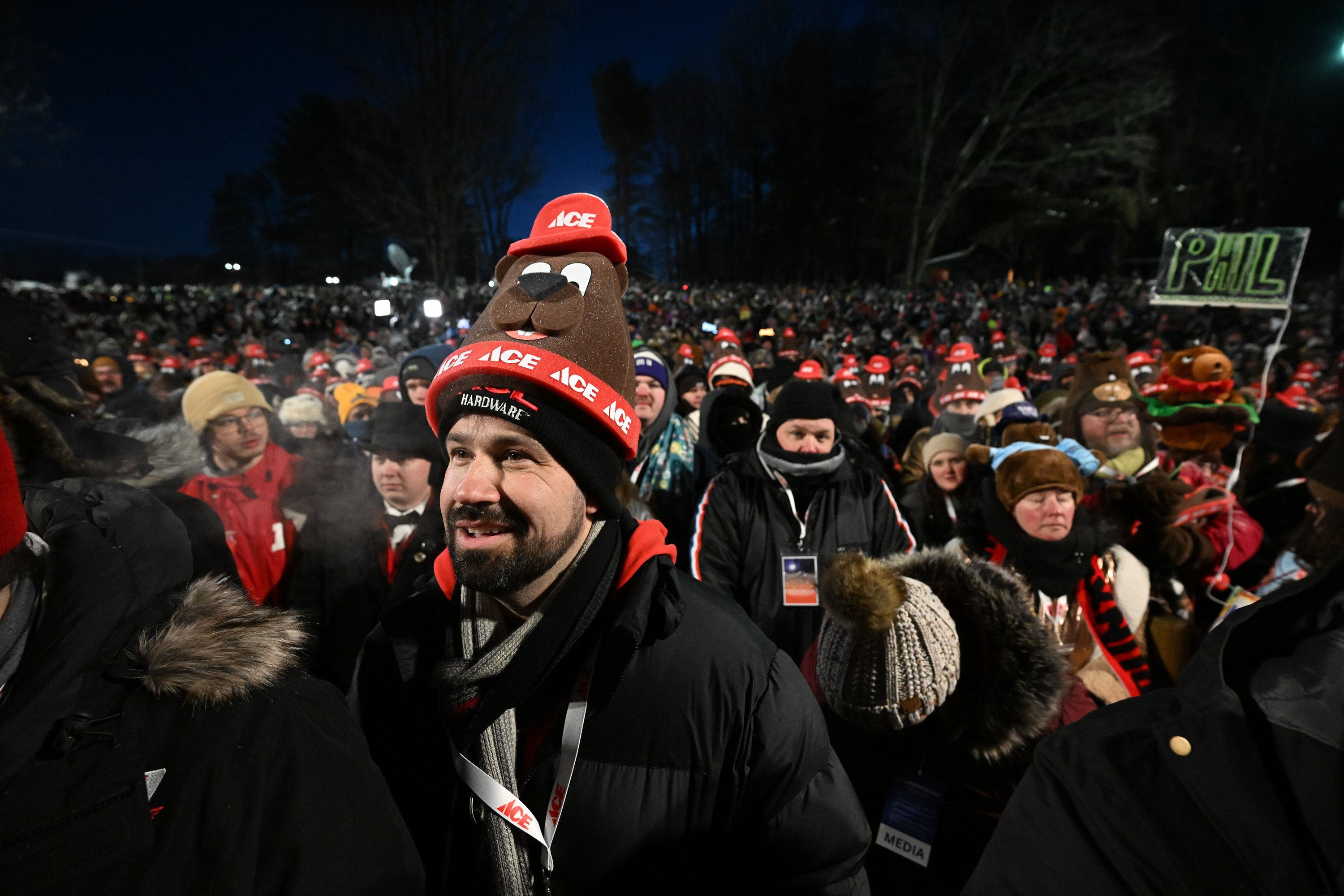 A crowd waits for Punxsutawney Phil, the weather prognosticating groundhog,...