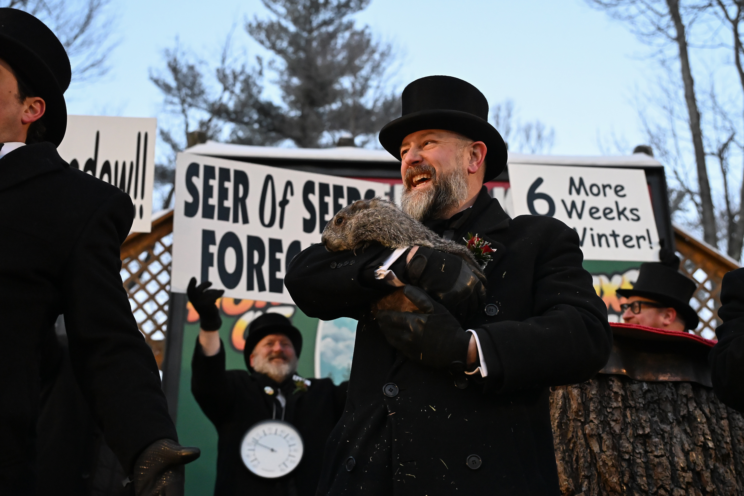 Groundhog Club handler A.J. Dereume holds Punxsutawney Phil, the weather...