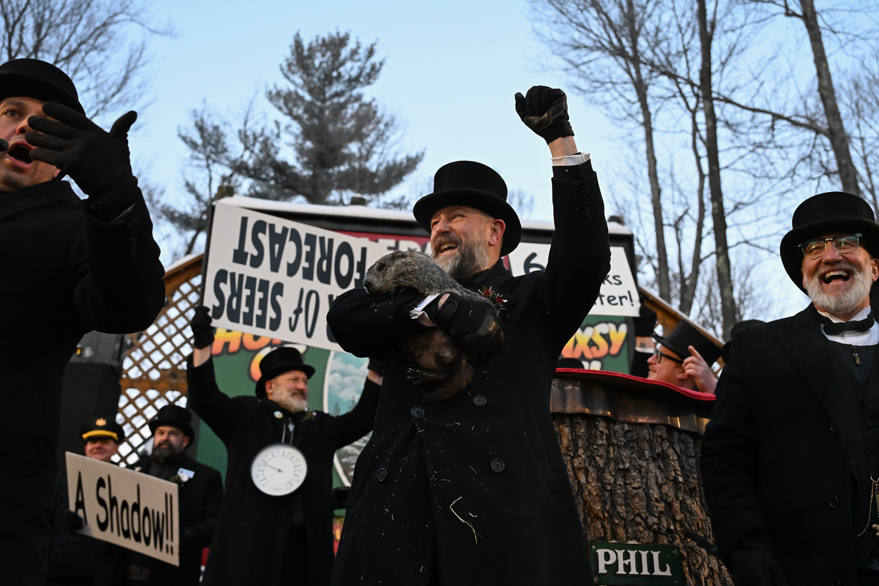 Groundhog Club handler A.J. Dereume holds Punxsutawney Phil, the weather...