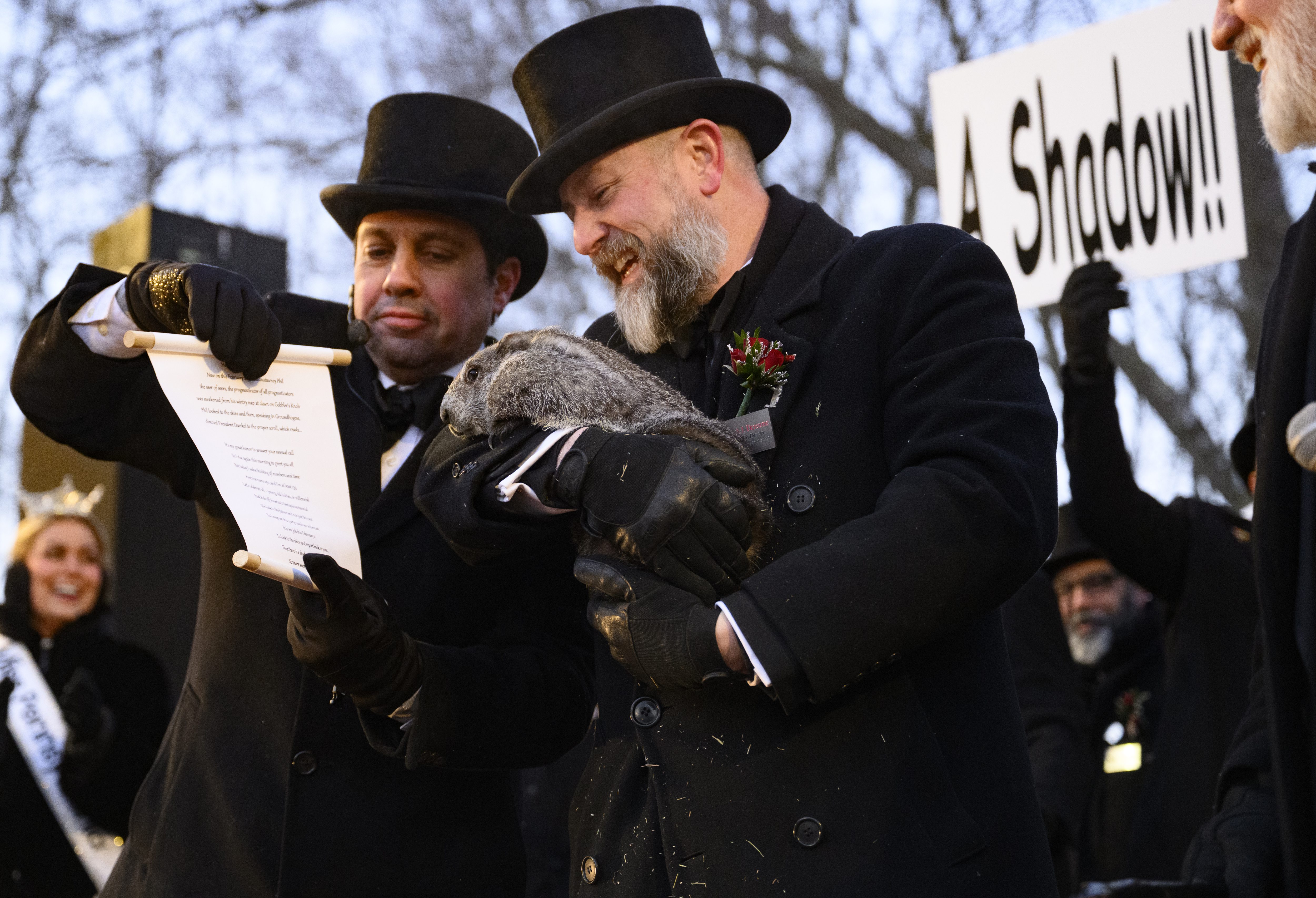 Groundhog handler AJ Dereume holds Punxsutawney Phil after he saw...
