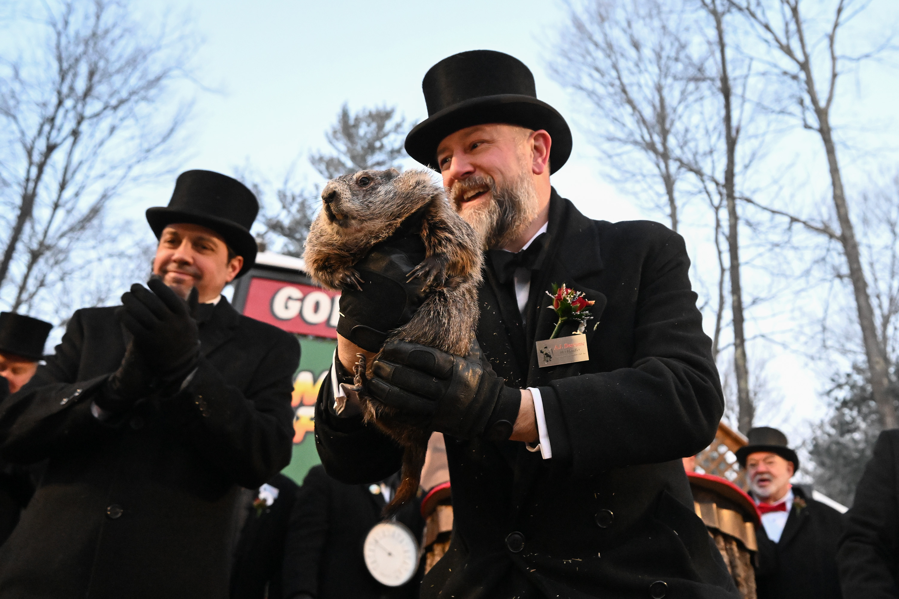 Groundhog Club handler A.J. Dereume holds Punxsutawney Phil, the weather...