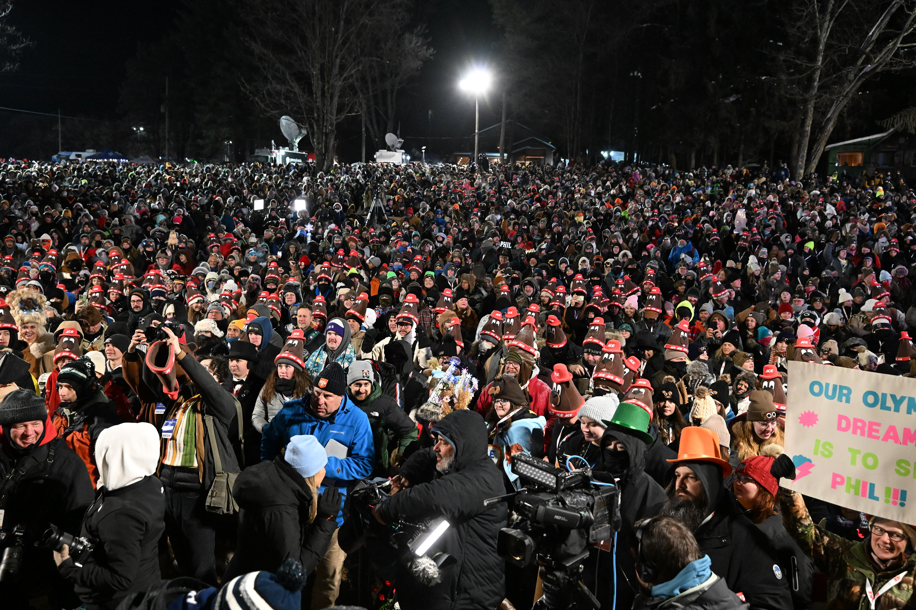 A crowd gathers while waiting for Punxsutawney Phil, the weather...