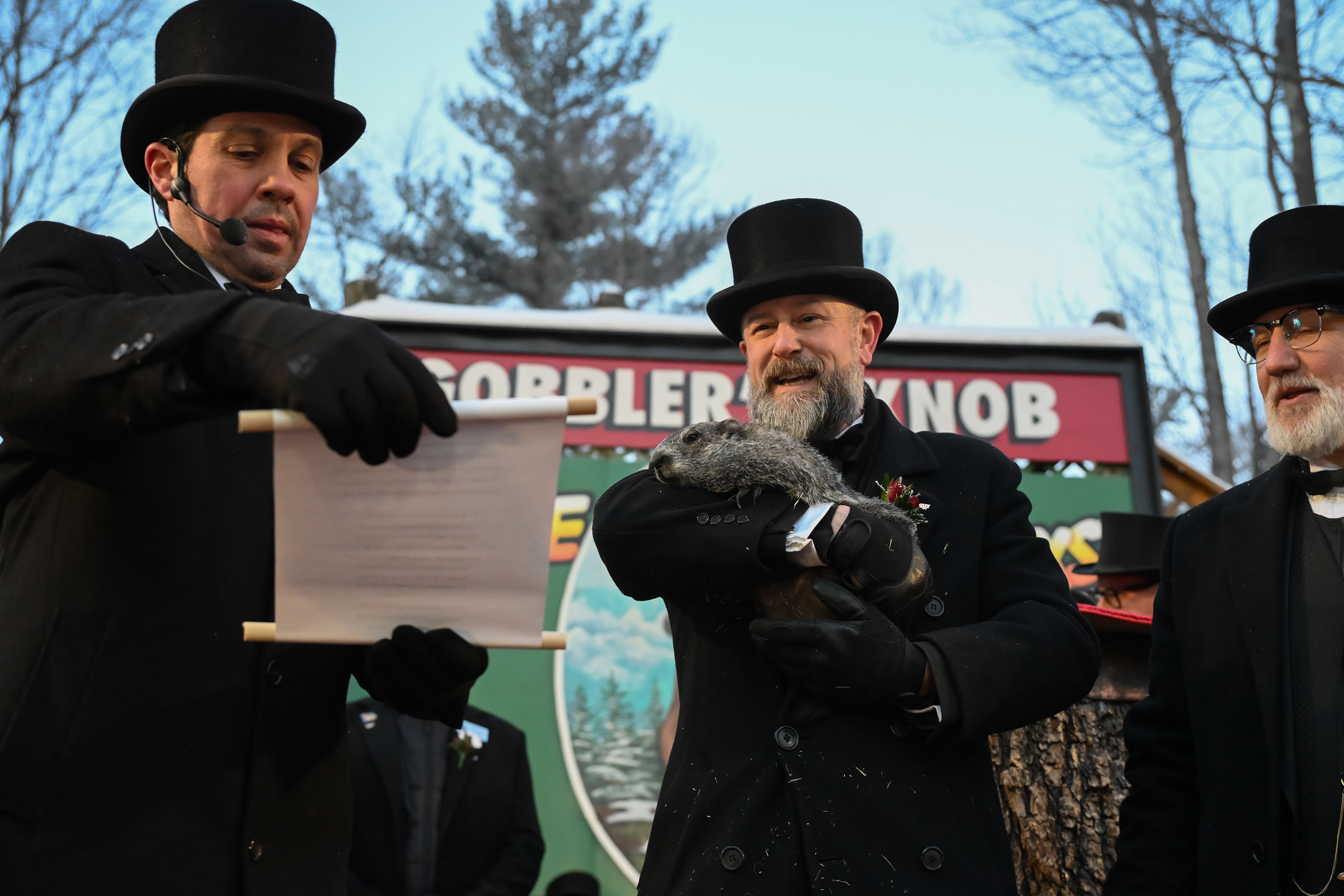 Groundhog Club Vice President Dan McGinley reads the scroll as...