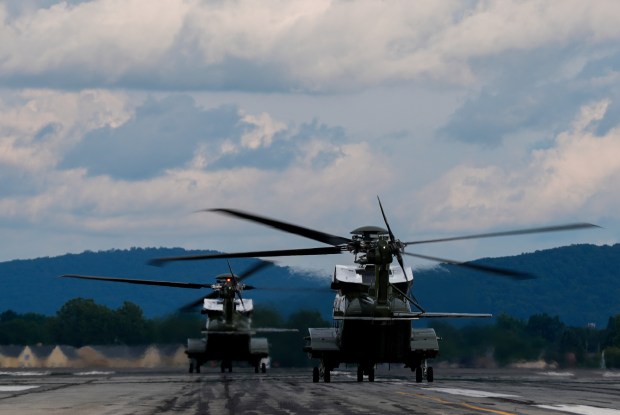 Marine One carrying President Donald Trump, left, takes off from Lehigh Valley International Airport, Friday, Aug. 1, 2025, near Allentown en route to Bedminster, New Jersey. (Julia Demaree Nikhinson/AP)