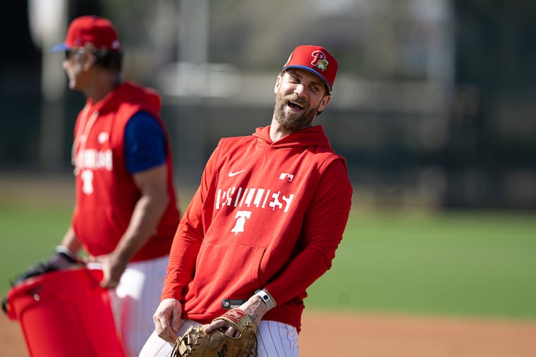 Philadelphia Phillies Bryce Harper, right interacts with coach, Don Mattingly during the first full-squad workout of spring training Monday, Feb. 16, 2026, at BayCare Ballpark in Clearwater, Florida.