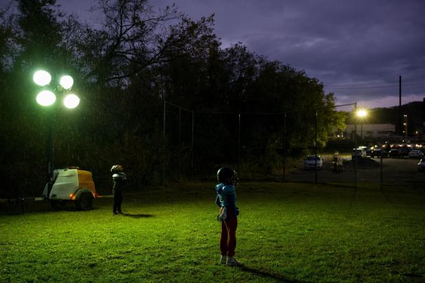 Youth football players stand in the rain at practice across the street from the Clairton Coke Works in Clairton, Pa., on Thursday, Oct. 23, 2025. (Quinn Glabicki/Pittsburgh's Public Source via AP)