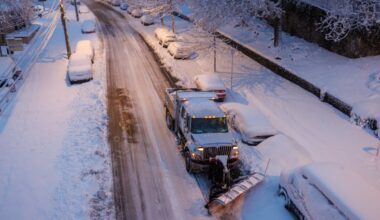Sanitation Department dump truck clears snow on Midvale Avenue in the East Falls section of Philadelphia on Monday, Feb. 23, 2026. On Wednesday, Feb. 25, sanitation crews will resume trash and recycling collection.