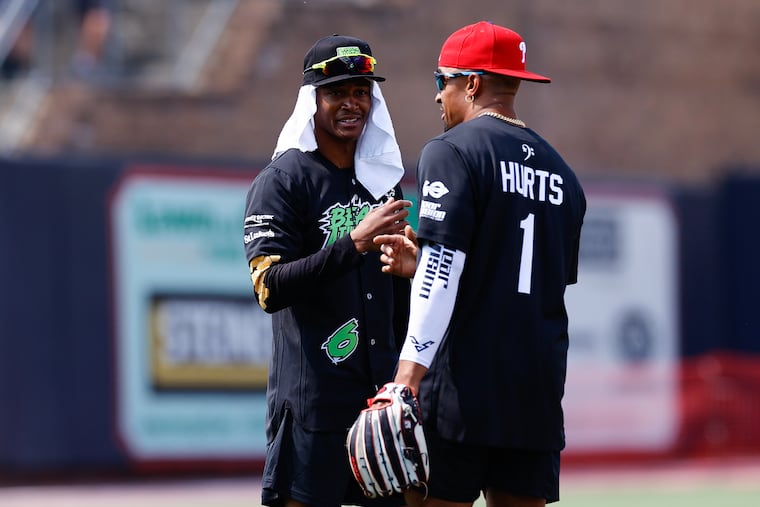 Eagles wide receiver DeVonta Smith (left) shown with quarterback Jalen Hurts during the Smith's celebrity softball game in 2023.