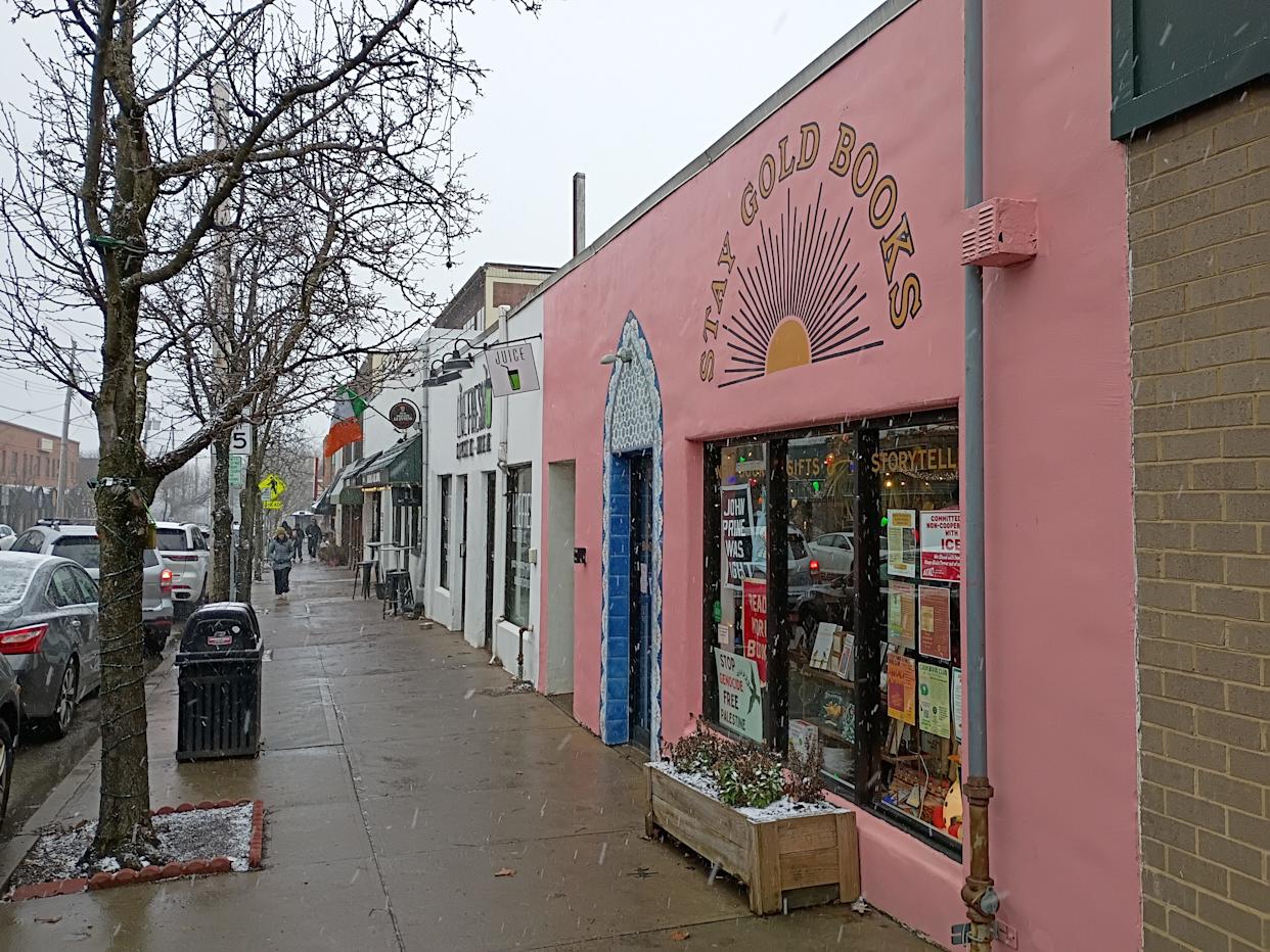 View of street in Regent Square with exterior of Stay Gold Books