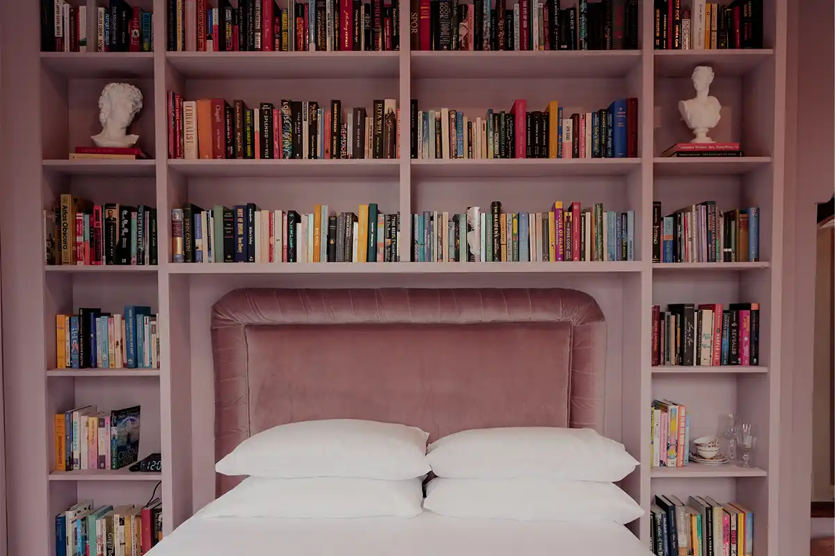 Rose's Room at The Bookhouse at Faubrook with pink built-in shelves around bed