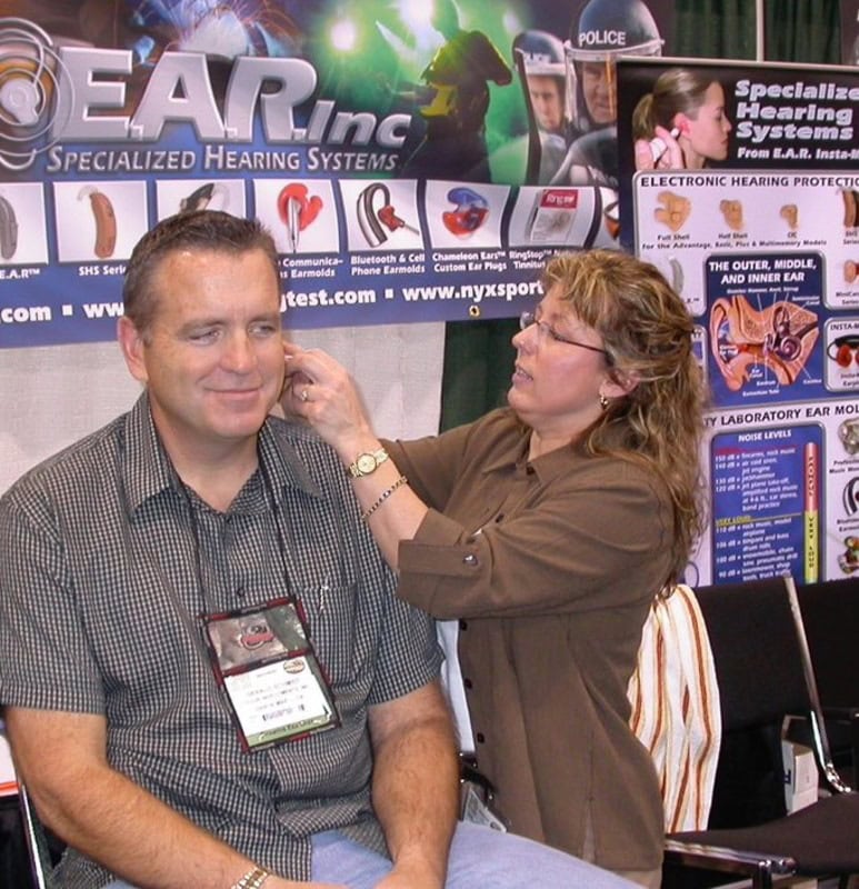 Custom earplugs being fitted for a customer at an EAR Customized Hearing Protection booth.