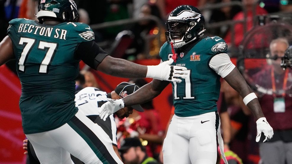 Philadelphia Eagles wide receiver A.J. Brown (11) is congratulated by teammate Mekhi Becton (77) after catching a touchdown pass during the first half of the NFL Super Bowl 59 football game against the Kansas City Chiefs, Sunday, Feb. 9, 2025, in New Orleans. (AP Photo/Doug Benc)