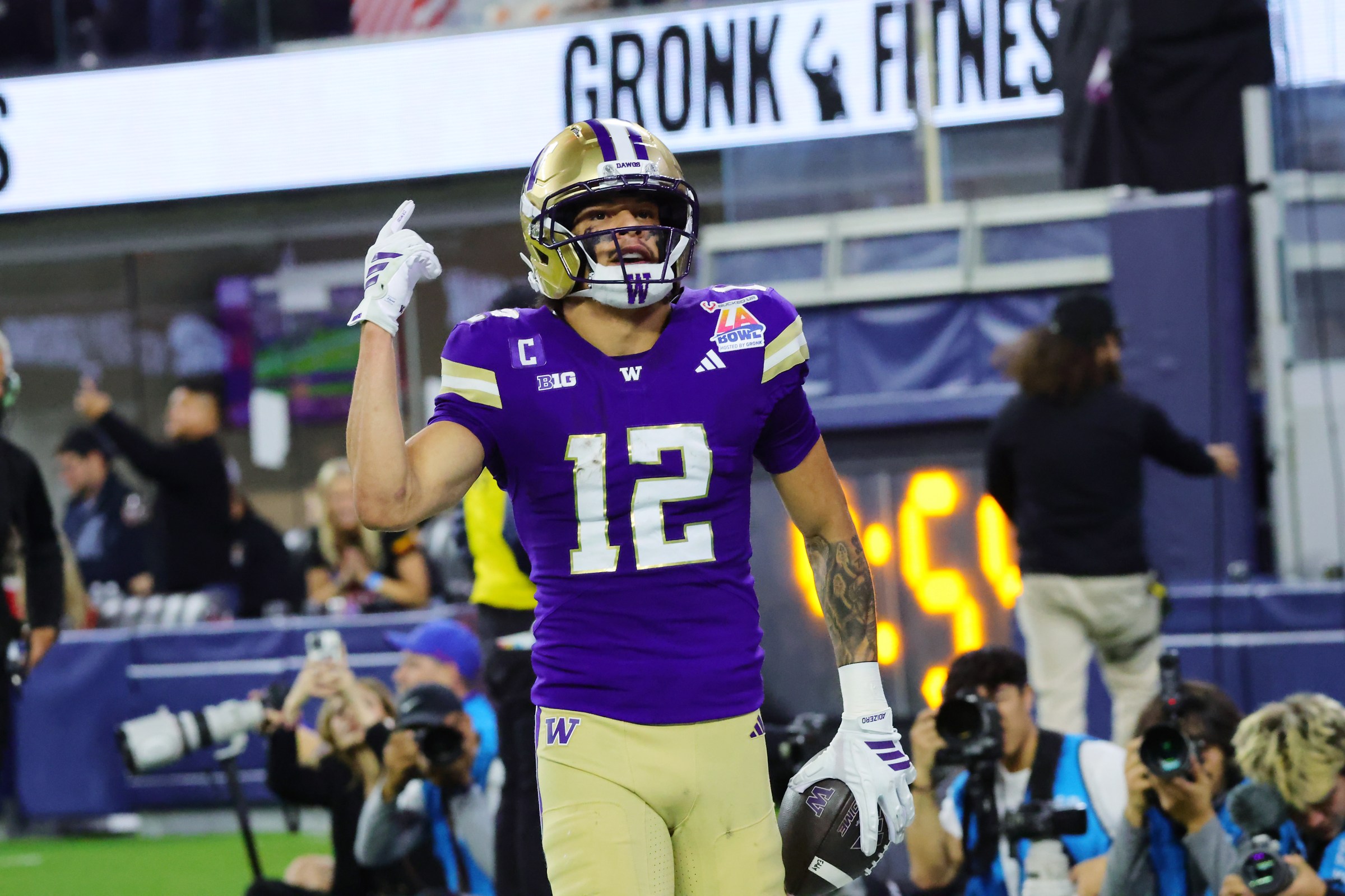 INGLEWOOD, CALIFORNIA - DECEMBER 13: Wide receiver Denzel Boston #12 of the Washington Huskies scores on a reception against the Boise State Broncos during the first half of the LA Bowl Game at SoFi Stadium on December 13, 2025 in Inglewood, California. (Photo by Kevin Terrell/Getty Images)