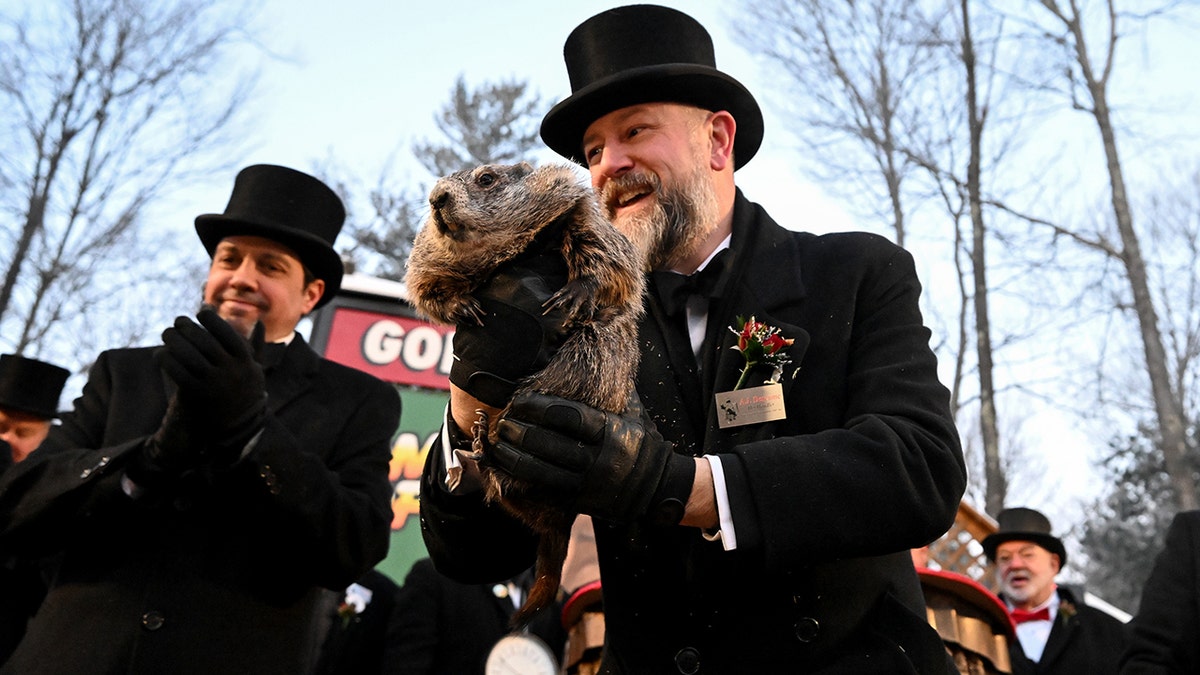 Groundhog Club handler A.J. Dereume holds Punxsutawney Phil