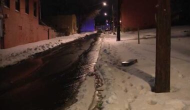 Water gushes down Perry Street and Wylie Avenue in Pittsburgh