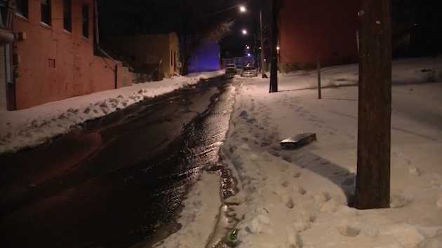 Water gushes down Perry Street and Wylie Avenue in Pittsburgh