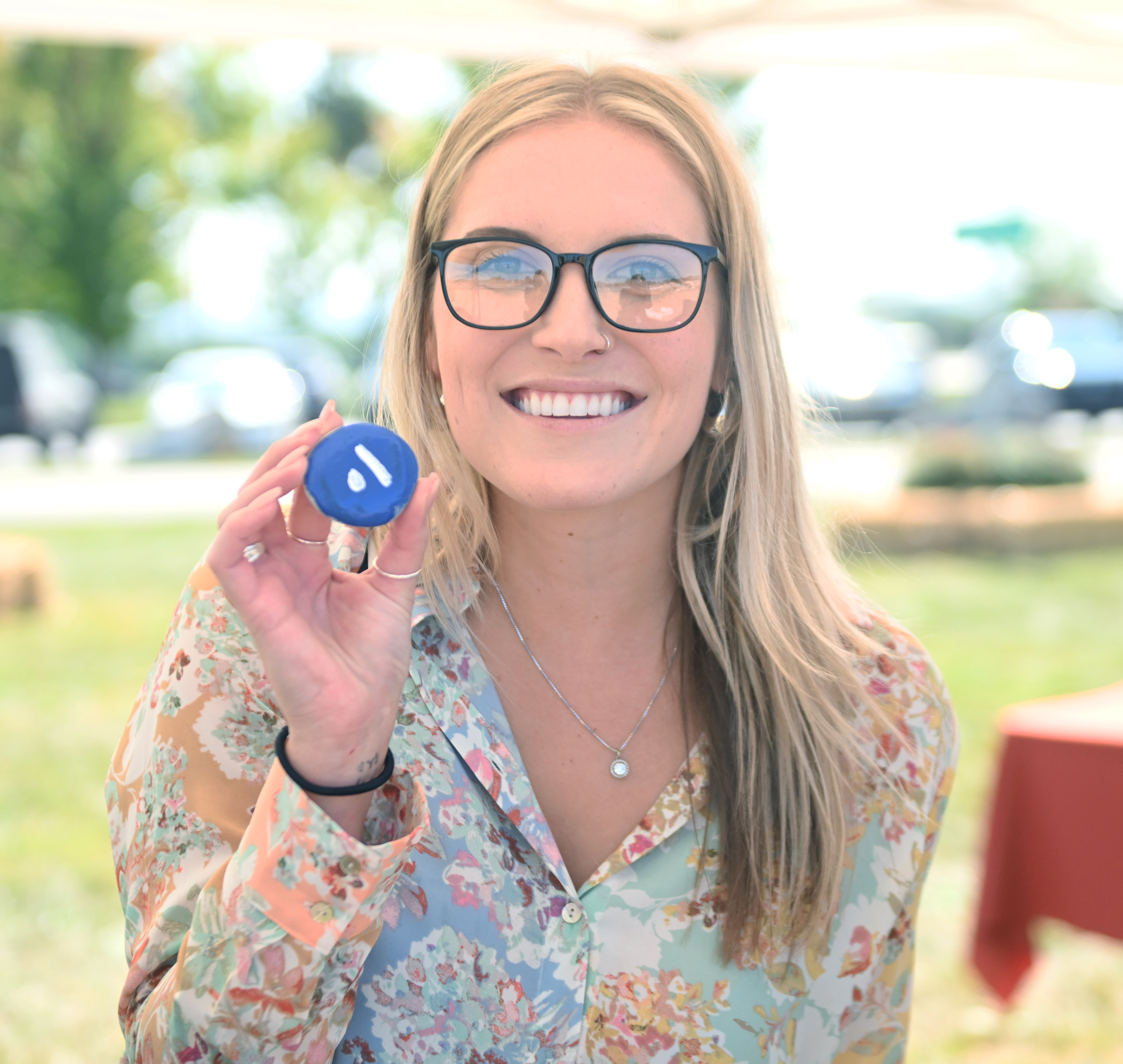 Krista Berardelli paints a rock to decorate the future community...