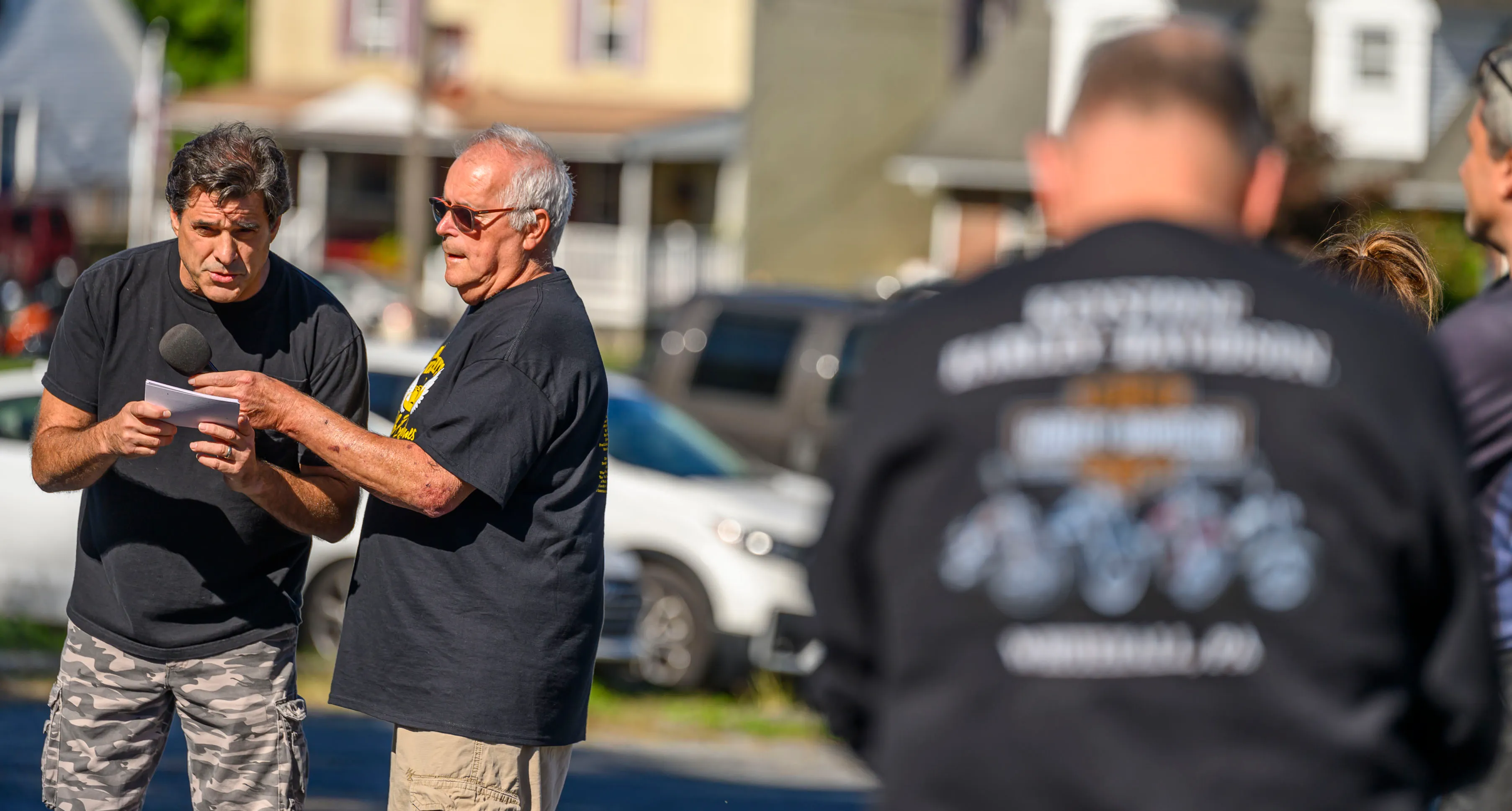 John Wescoe says a prayer as Chuck Deprill stands next...