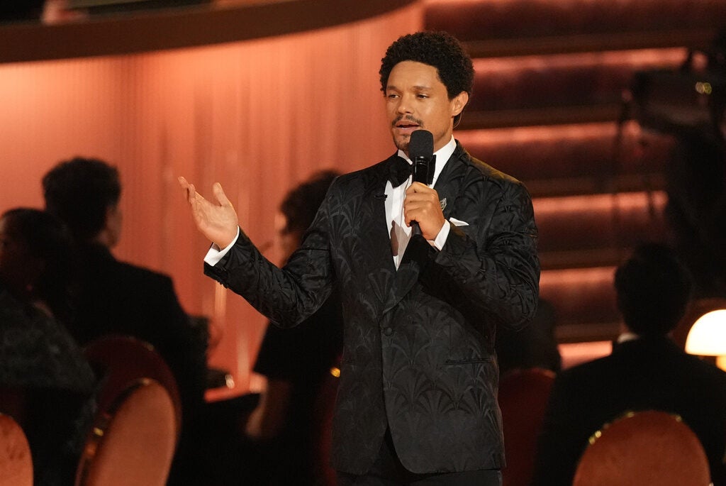 Host Trevor Noah speaks into a microphone during the 68th annual Grammy Awards