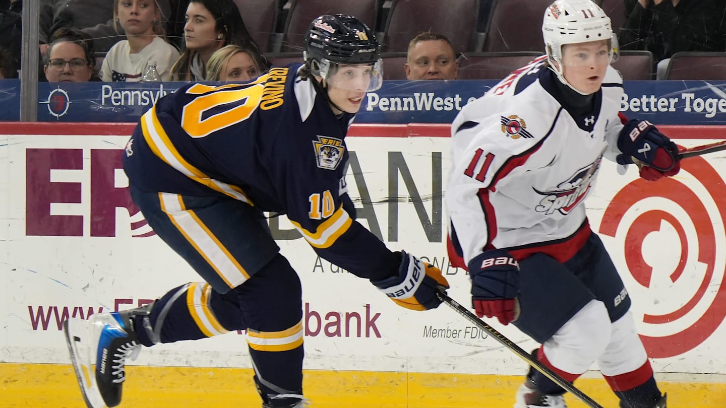 Erie Otters defenseman Tristen Trevino, left, competes near Windsor Spitfires forward Caden Harvey at Erie Insurance Arena in Erie on Jan. 16, 2026.
